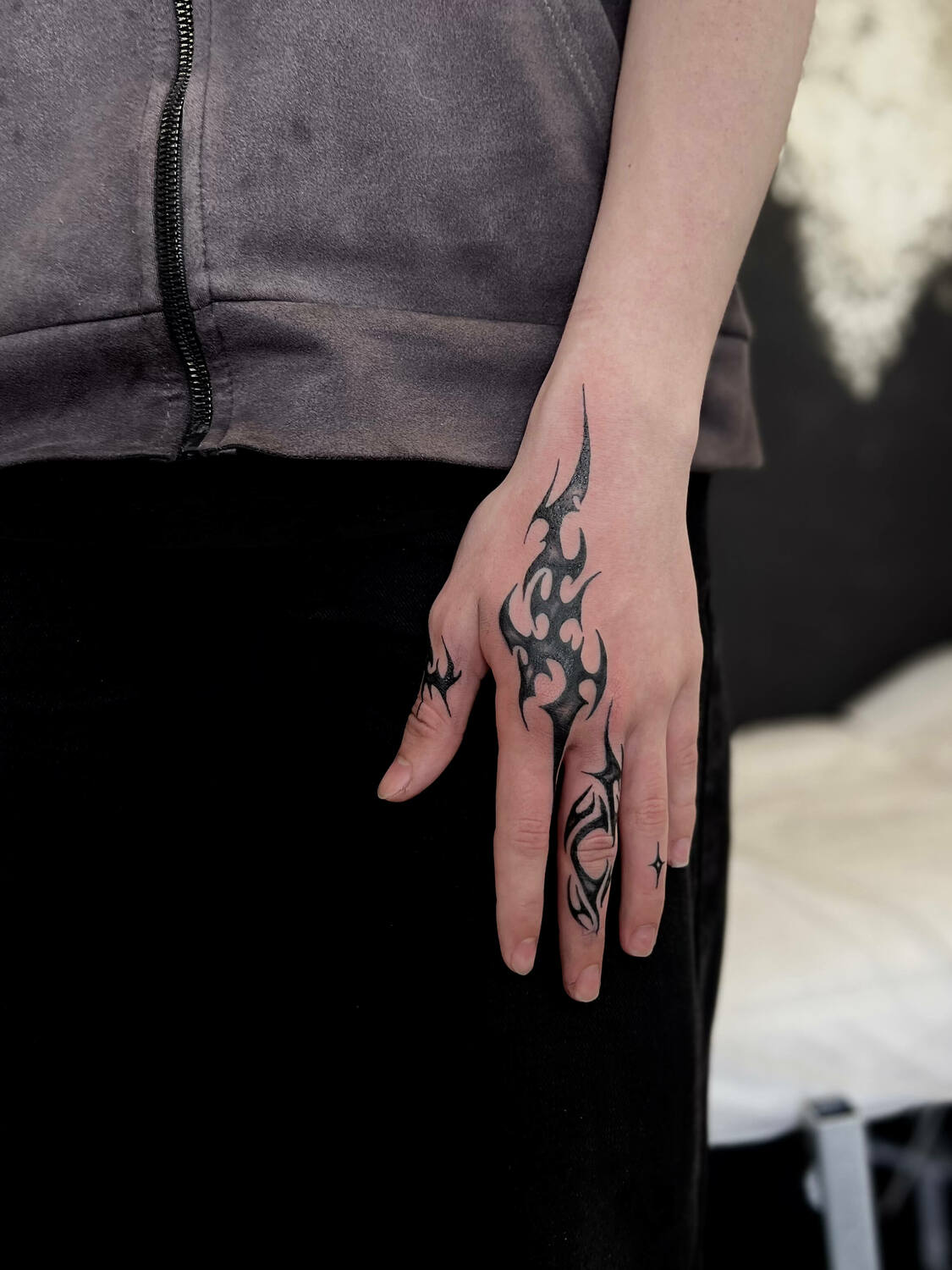 Трайбл татуировка на кисти и пальцах в черном стиле